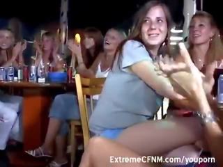 Cute Girls suck pecker in a club